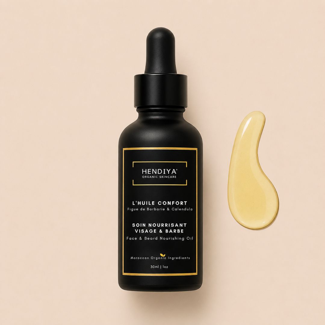 Bottle of Hendiya L'Huile Confort, nourishing face and beard oil for men with prickly pear seed oil and calendula, amber glass packaging with dropper.