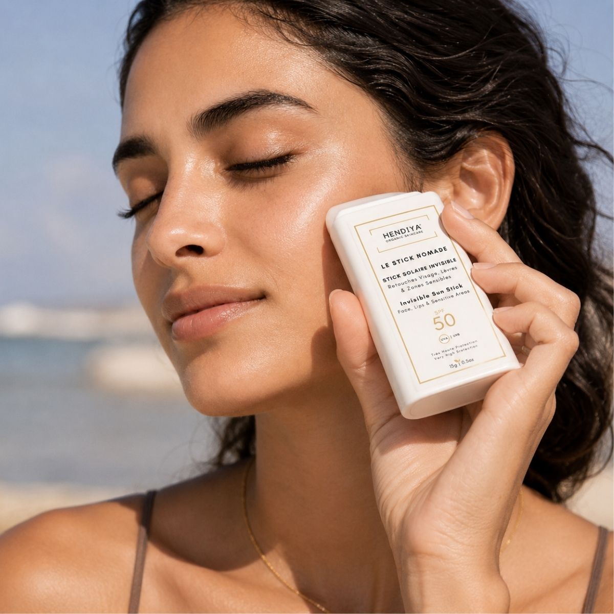 Applying Le Stick Nomade SPF 50+ to sensitive areas of the face
